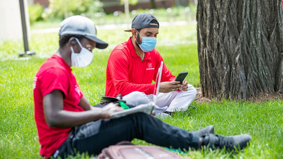 Photo Credit: Students with masks studying on campus