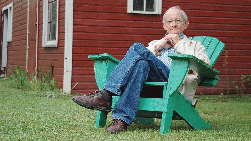 Ted Kooser sitting in an adirondack chair ; links to news story