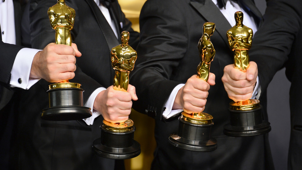 Image of actors holding Academy Award trophies; links to news story