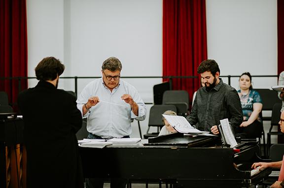 Tyler White (center) rehearses with Patrick McNally (left) and Matthew Gerhold. ; links to news story