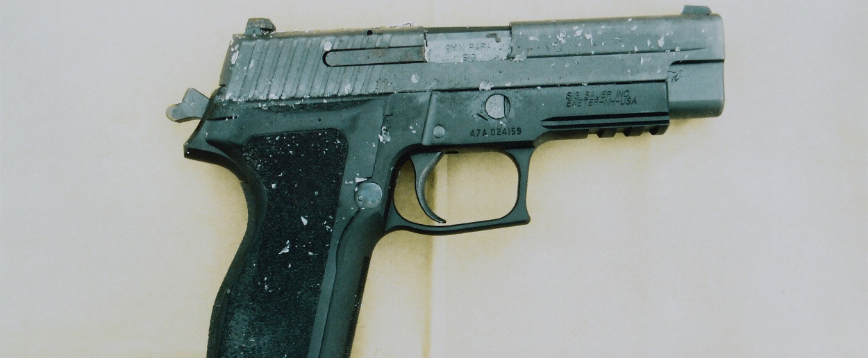 A battered and scuffed handgun