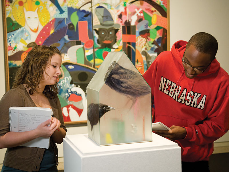 Students view an exhibition at the Sheldon Museum of Art.