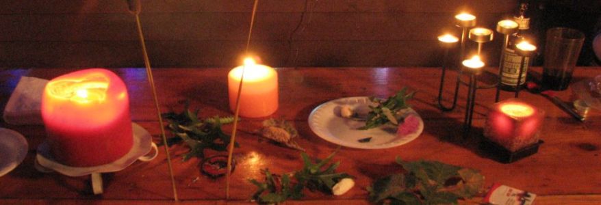 Table with lit candles and trinkets