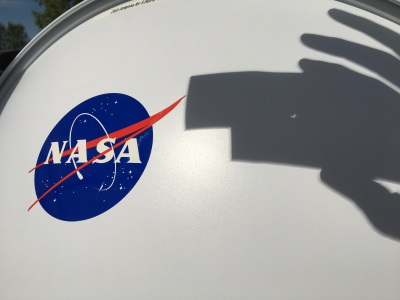 Shadow of the eclipse across a NASA-branded dish antenna
