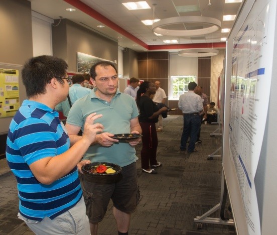 Photo Credit: Junlei Wang explains his research to Postdoc Ather Mahmood.