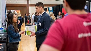 A student talks to a recruiter at the career fair.