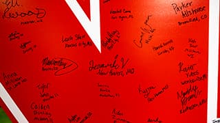 Signatures from admitted high school seniors decorate a large, red Nebraska 'N' on Admitted Student Day on March 23.