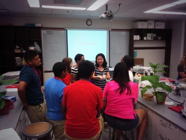 July, 2014. Grad student Panya Kim showing high school students how to infiltrate tobacco for an HR assay at a workshop at UNL.