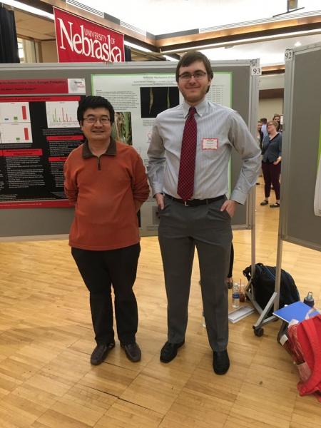 April, 2016 . Micro major Sam Eastman (in tie) with his lab mentor Guangyong Li presenting poster at UNL Undergrad Poster Session.