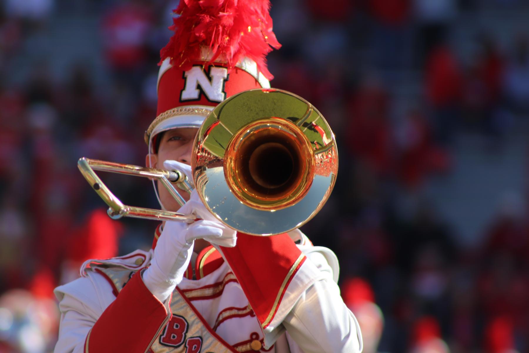 Photo of a Cornhusker Marching Band trombone player at Memorial Stadium.