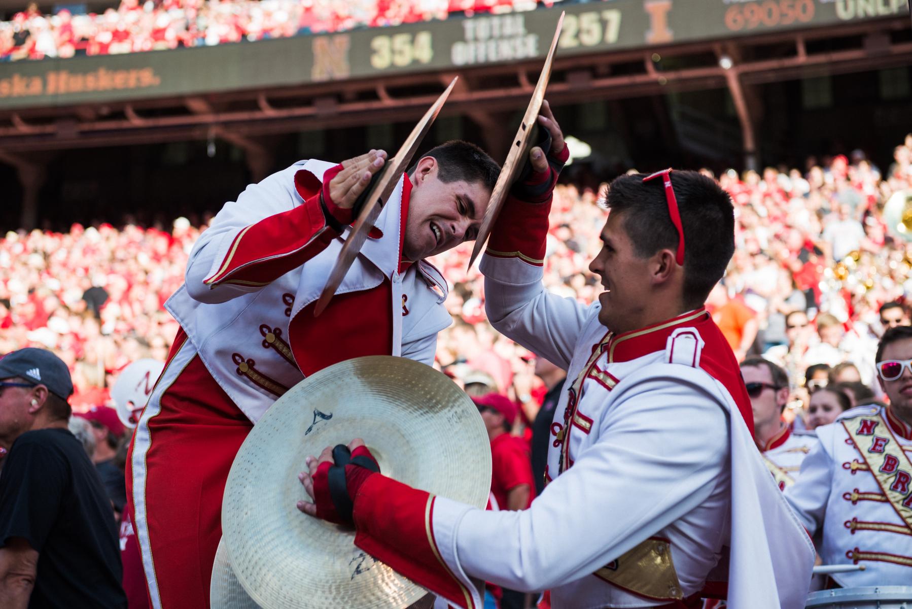 Photo of Cornhusker Marching Band cymbal players at Memorial Stadium.