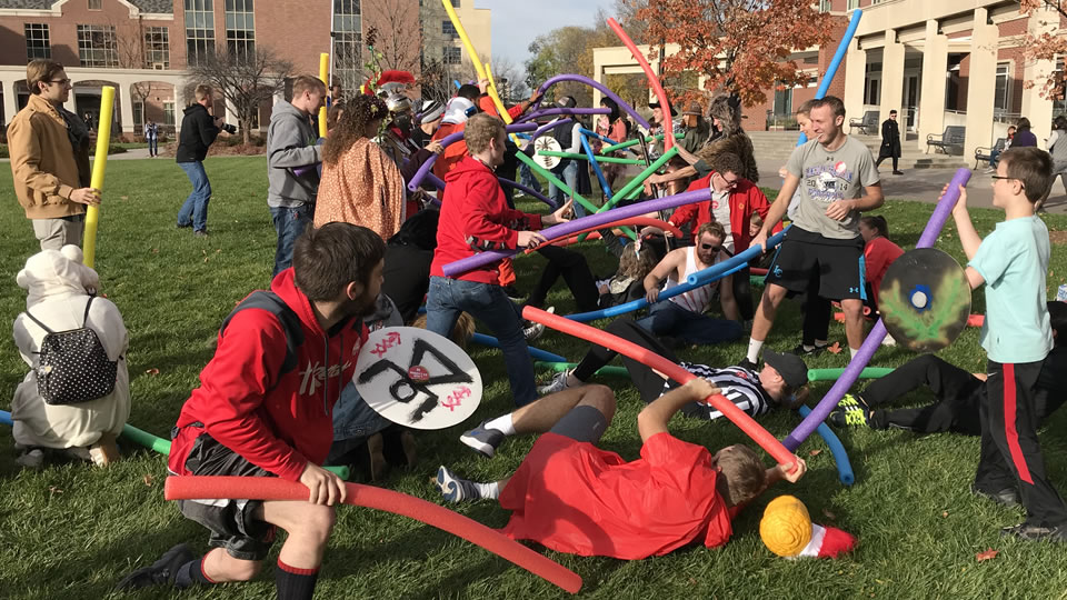 Daily Nebraskan: Annual Classics Club reenactment features pool noodle-wielding students