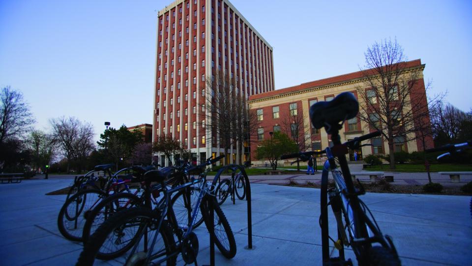 Winter scene with bikes on campus; links to news story