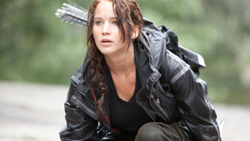 Jennifer Lawrence portraying Katniss Everdeen in the film THE HUNGER GAMES; links to news story