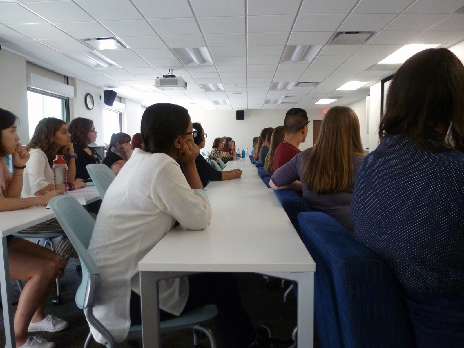 Graduate students listen intently during an orientation meeting