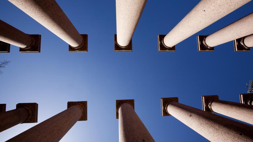 Columns flanked by blue sky on UNL city campus; links to news story