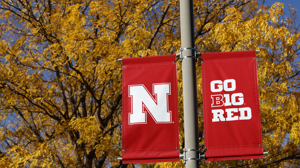 N and Go Big Red banners on a campus light pole; links to news story