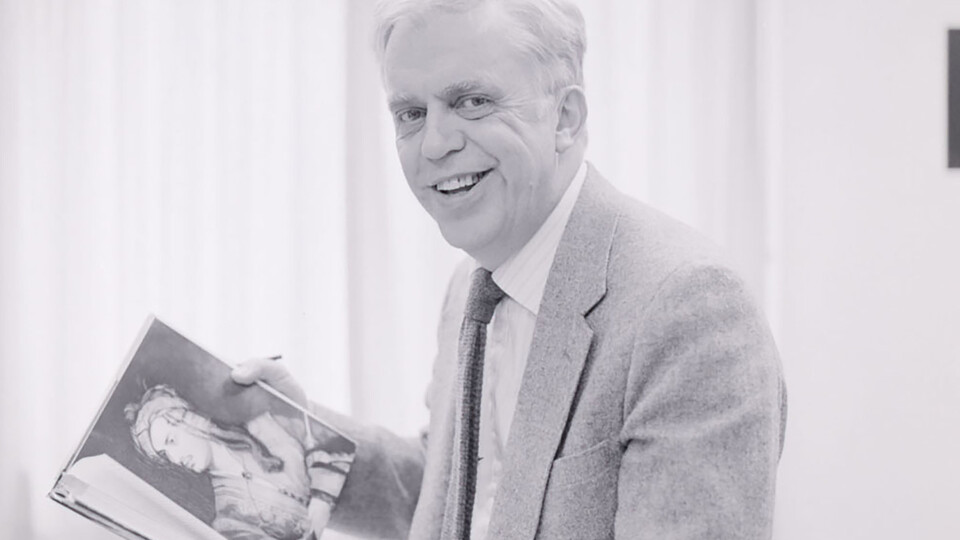 ouis Crompton holds his recently published book in this 1985 portrait; links to news story