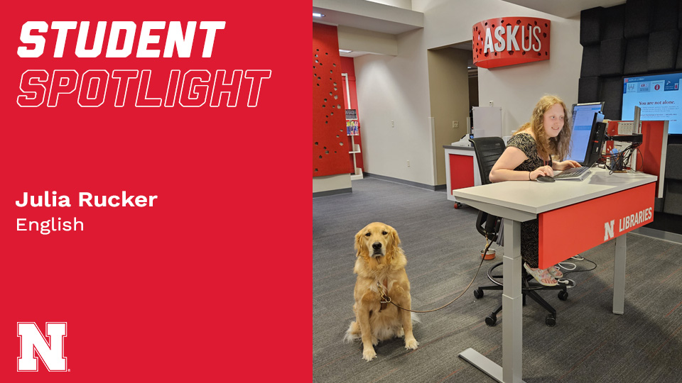 Julia Rucker and her service dog, Carson, work the ASKus Desk in Love Library South.; links to news story