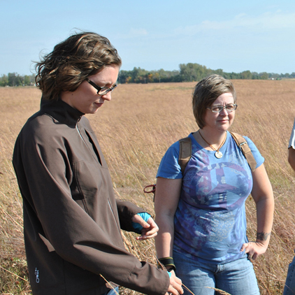 Students standing in a field during a writing retreat