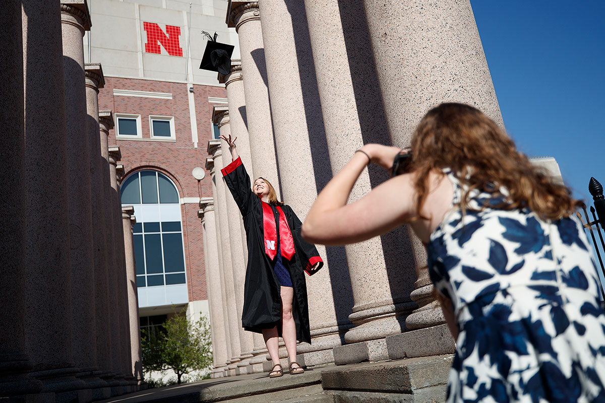 Rose Wehrman, 2020 English graduate, is photographed tossing her graduation cap by friend Sarah Schilling