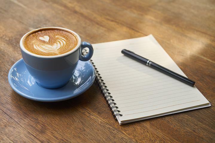Latte, notebook, and pen