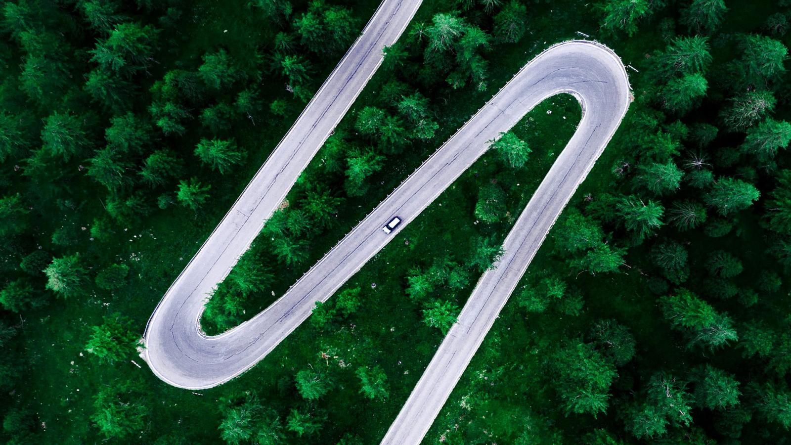 Aerial photo of road through forest