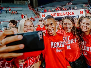 A group of students take a selfie in Memorial Stadium.
