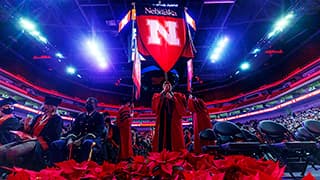 The Nebraska gonfolon leads the stage party into Pinnacle Bank Arena for Undergraduate Commencement.
