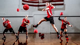 Four members of an intramural dodgeball team throw balls.