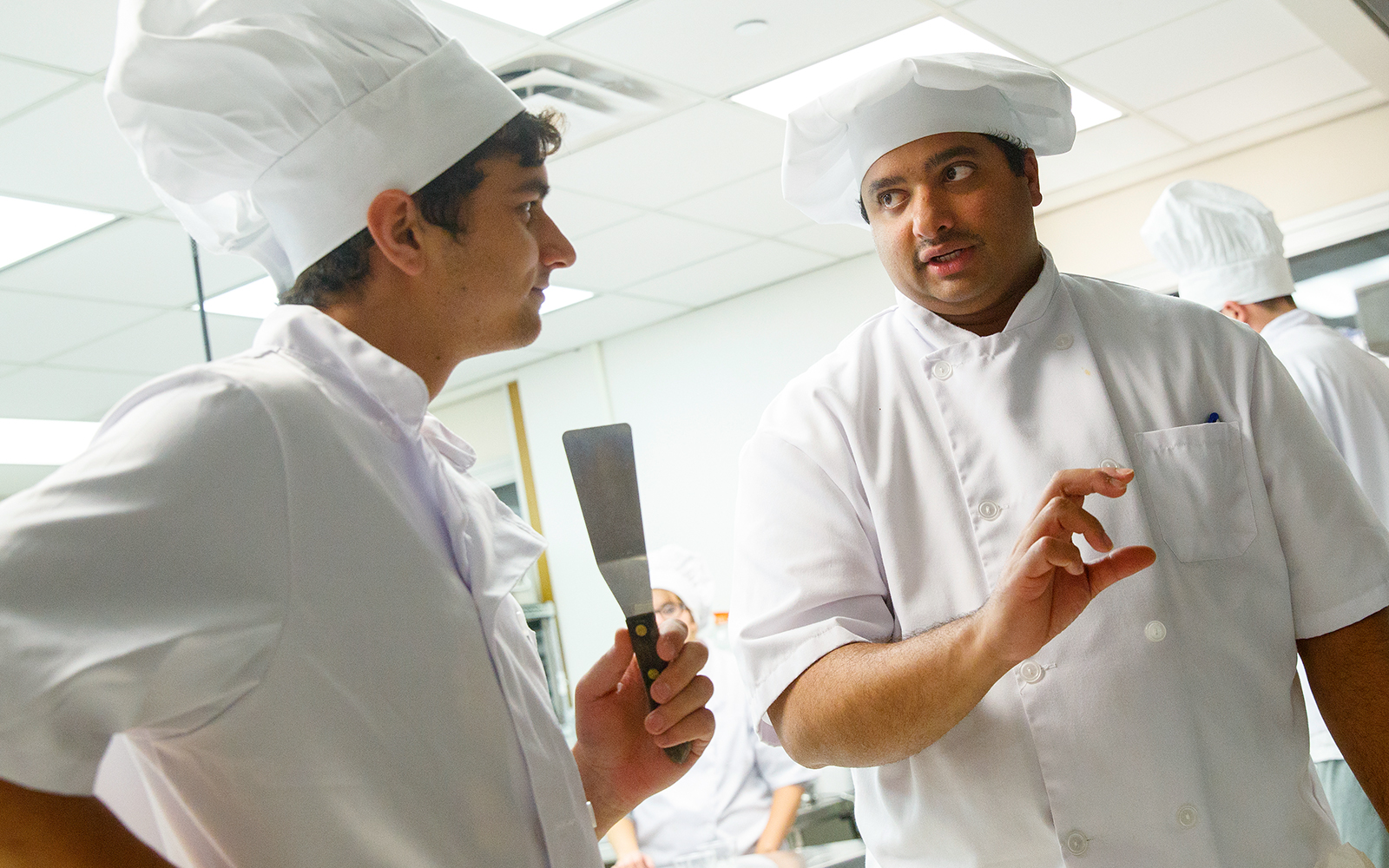 Ajai Ammachathram, working with HRTM students in the catering class in Leverton Hall.