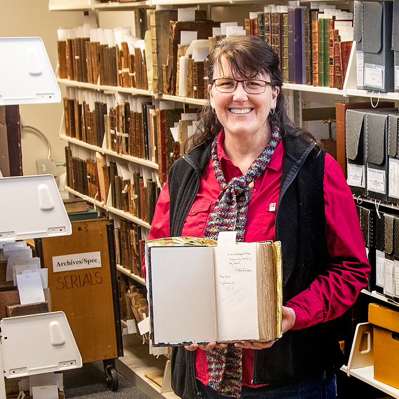 Mary Ellen Ducey in the archives library