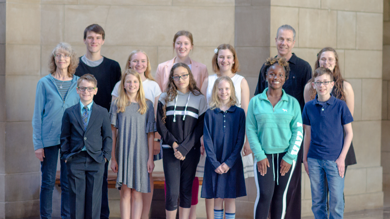 Group photo of winning student poets with former and current state poets Twyla Hansen and Matt Mason in the capitol rotunda