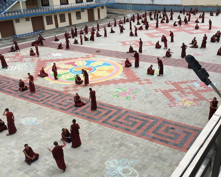 Tibetan monks debating in a courtyard