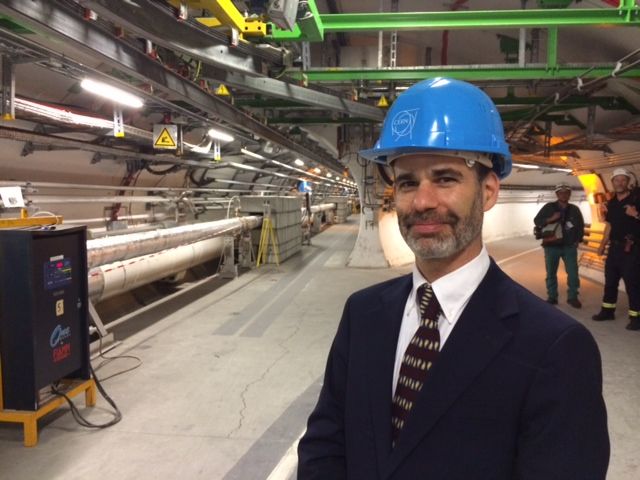 Ken Bloom posing in front of Large Hadron Collider