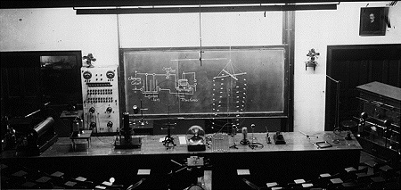 Classroom with blackboard and table of scientific equipment