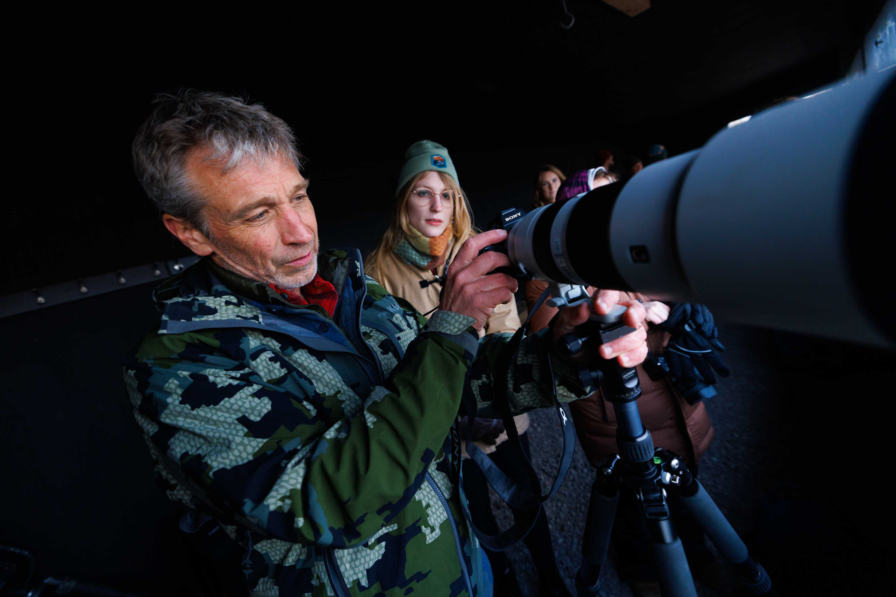Mike Forsberg (left) helps student Lilliane Roberts, a senior Fisheries and Wildlife major, set up their camera as they prepare to watch Sandhill Cranes arrive on the Platte River.