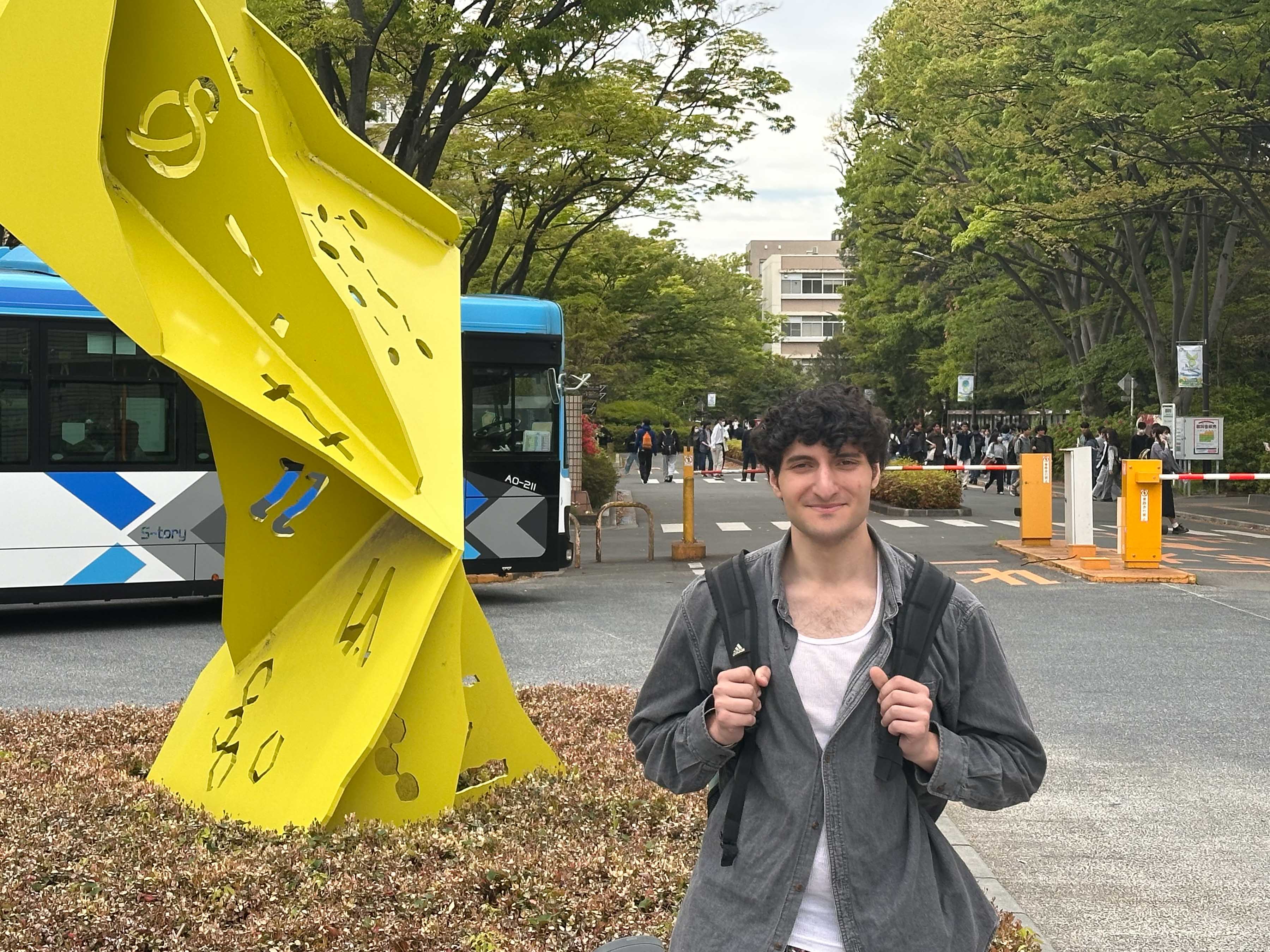 MJ Jabbar stands at the entrance of Saitama University in Japan. 