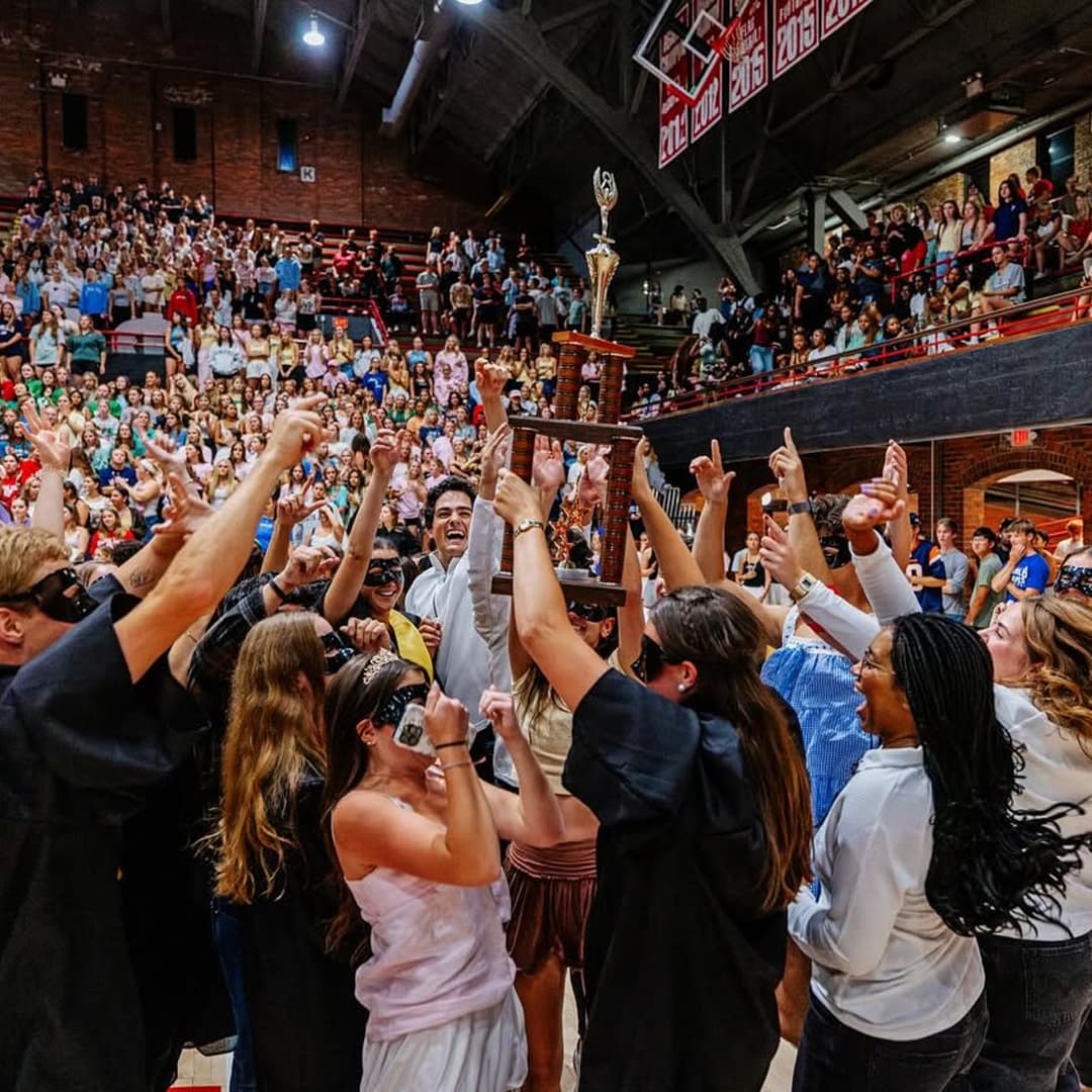 Winners cheer and hold up a trophy at the Showtime at the Coliseum event for Homecoming.