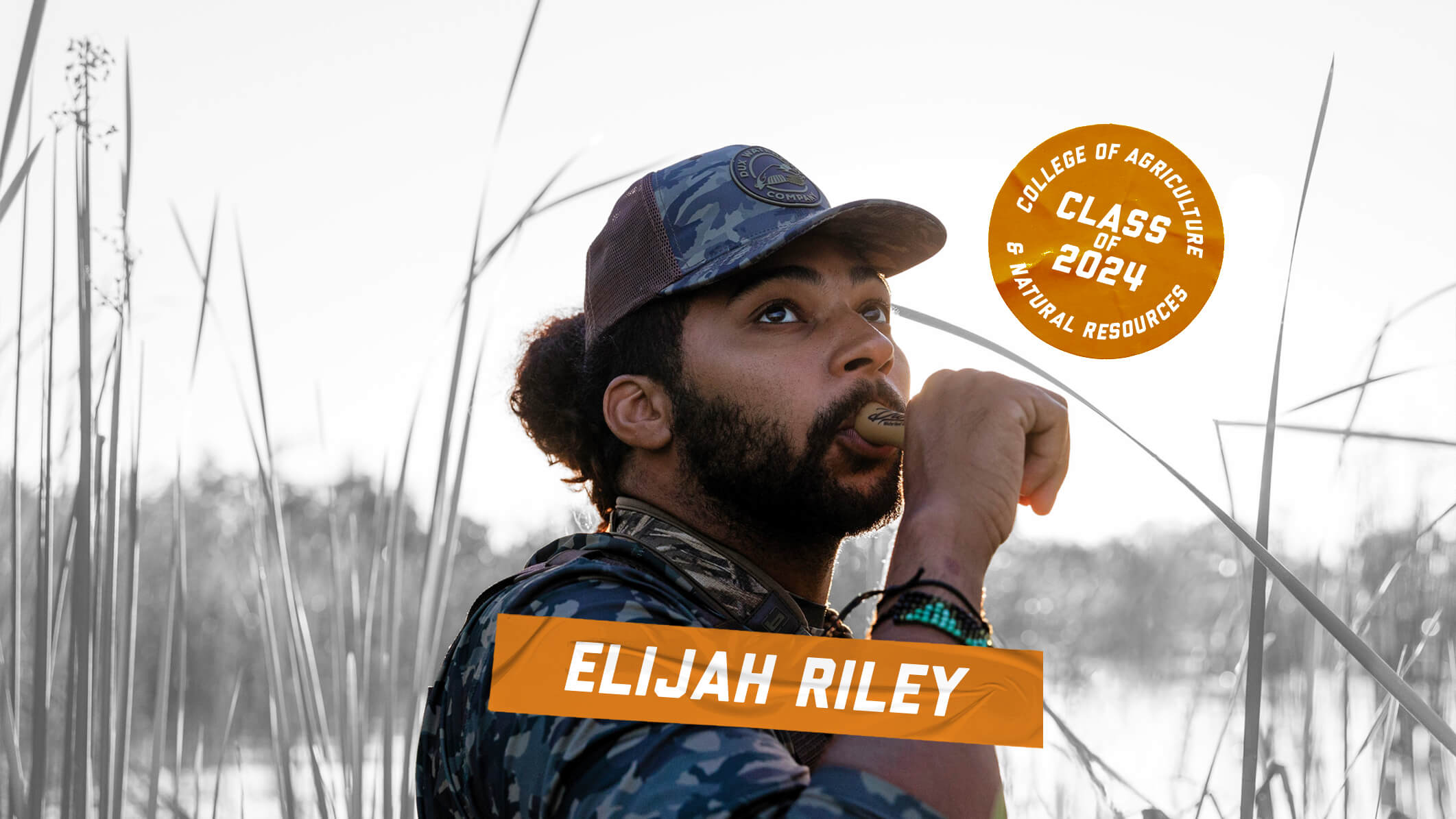 Man in camouflage surrounded by tall grass blowing a call, text overlay highlighting "Class of 2024".