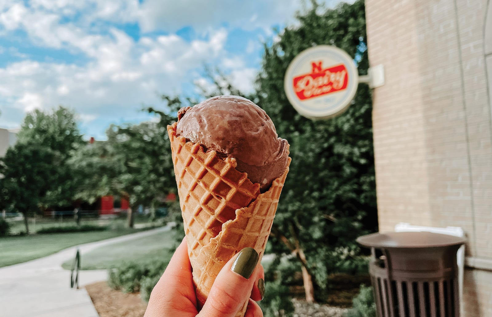 A scoop of chocolate ice cream held outside the UNL Dairy Store