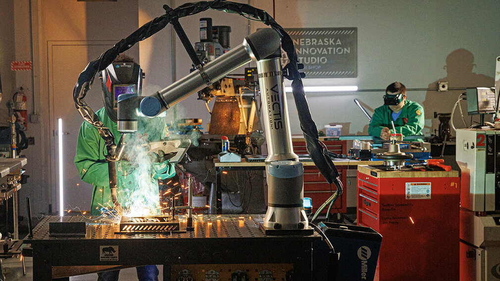 A Nebraska Innovation Studio member guides a welding robot in the metal shop. A Nebraska Innovation Studio member guides a welding robot in the metal shop.