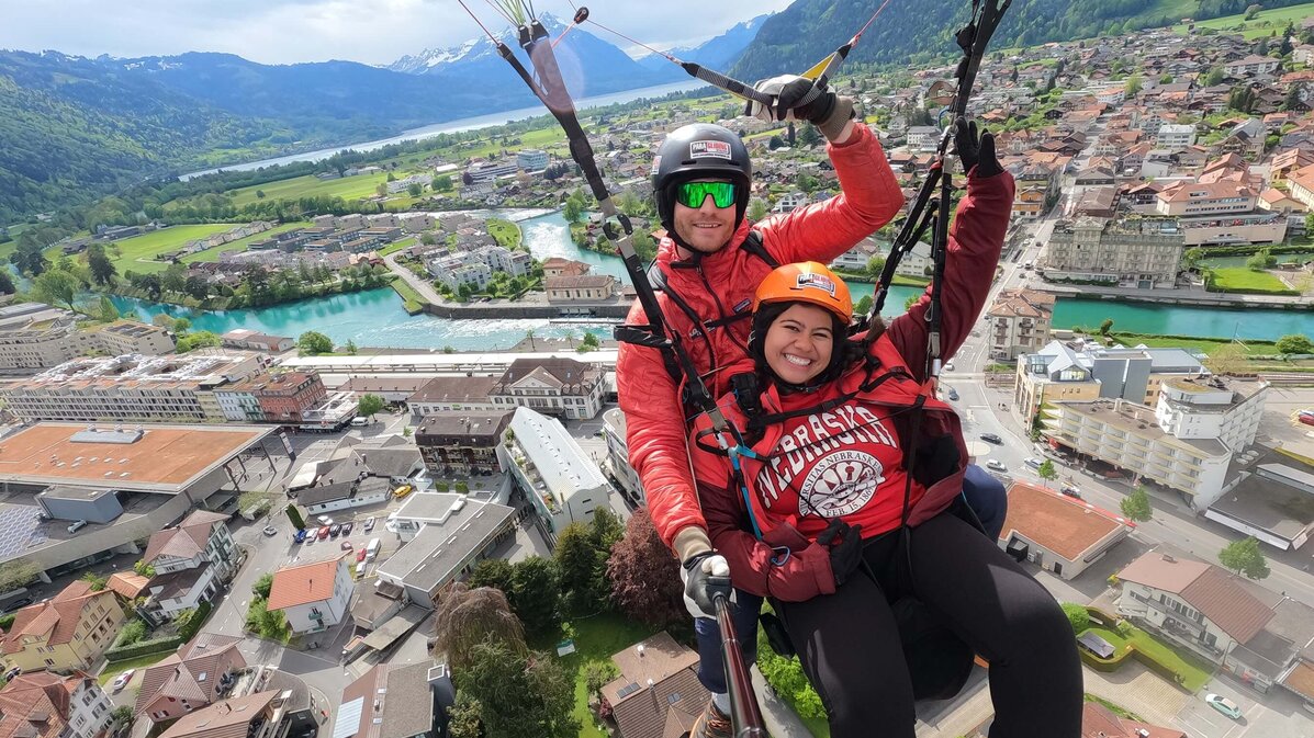 Jenny Castor smiles as she soars through the air with a skydiving instructor during a study abroad trip.