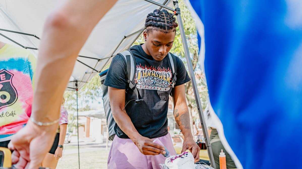 Students tie dye shirts at an event on campus