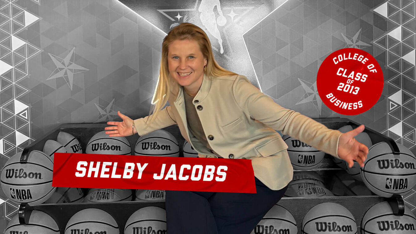 Shelby Jacobs posing with arms outstretched, seated among basketballs, text highlighting graduation achievements.