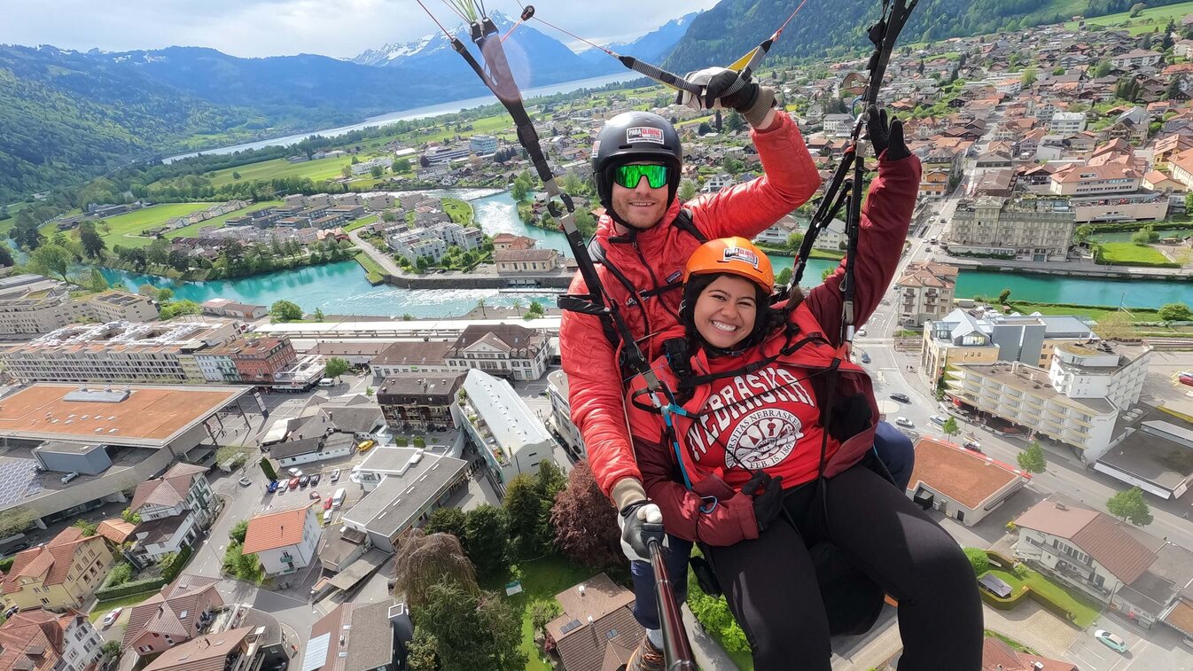 Jenny Castor smiles as she soars through the air with a skydiving instructor during a study abroad trip.