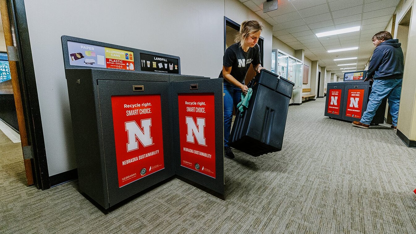 Staff place new recycling bins on campus