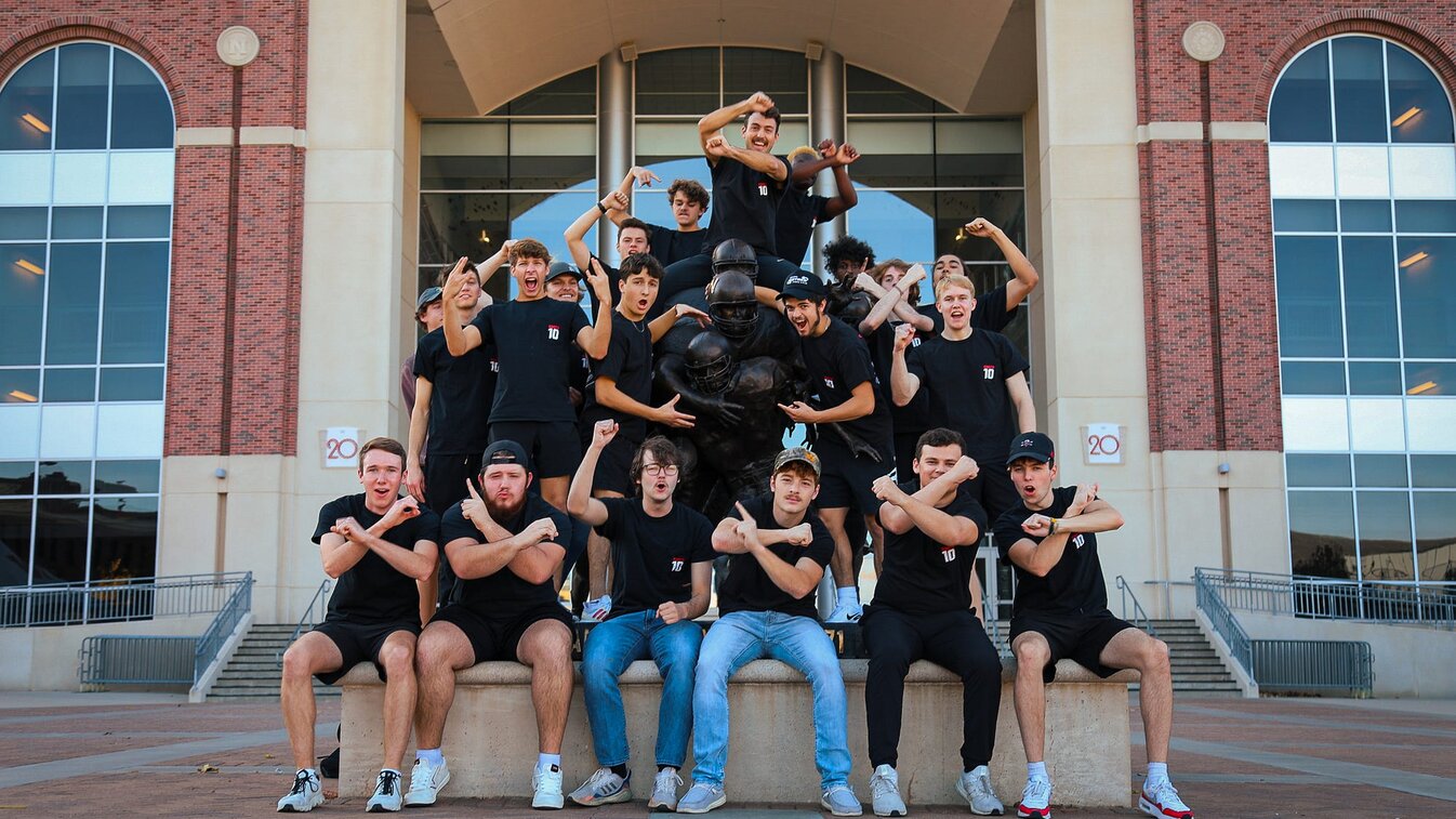 Tom and friends throw the bones and cheer outside of Memorial Stadium