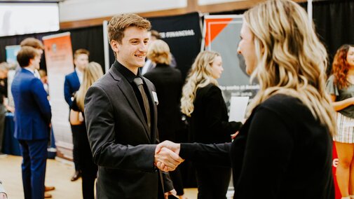 Tyler Mulliken talks with a recruiter from First Nebraska Bank at the Career and Internship Fair in Nebraska Union.