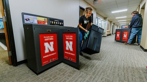 Staff place new recycling bins on campus